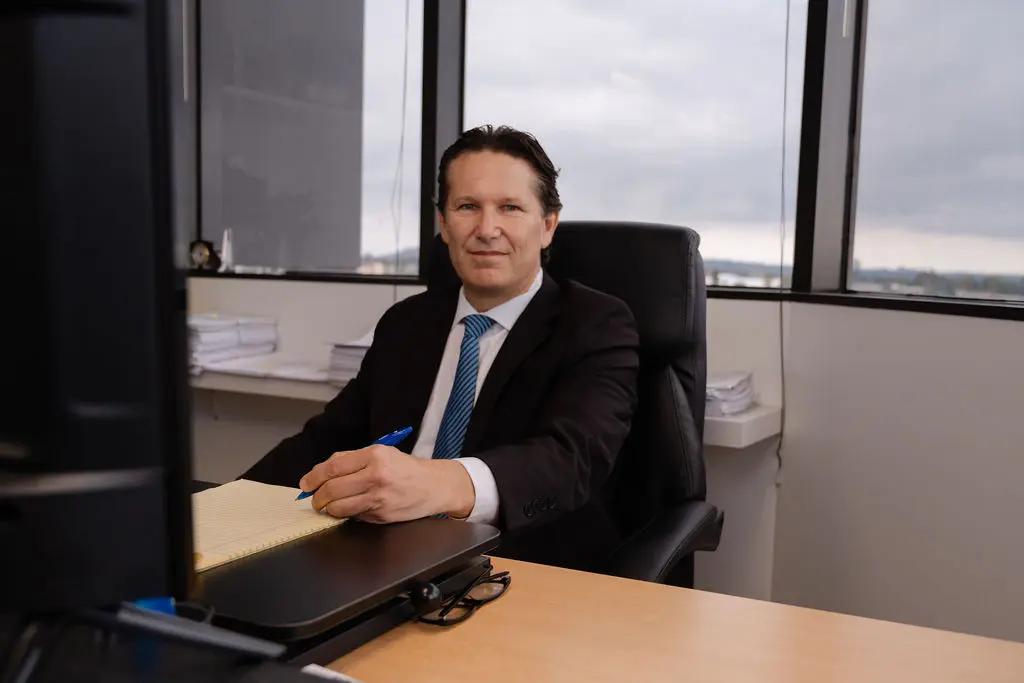 Picture of Kevin Singer: Court Receiver San Francisco sitting at his office desk